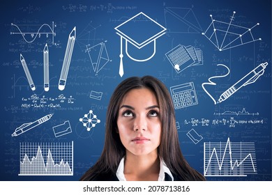 Portrait of attractive young european businesswoman with creative knowledge and graduation sketch on blue wall background. Education and academic concept - Powered by Shutterstock