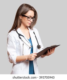 Portrait Of An Attractive Young Female Doctor In White Coat.