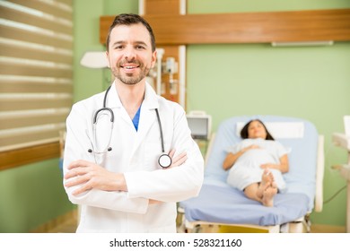 Portrait Of An Attractive Young Hispanic Obgyn Doctor Standing In A Hospital Room And Smiling