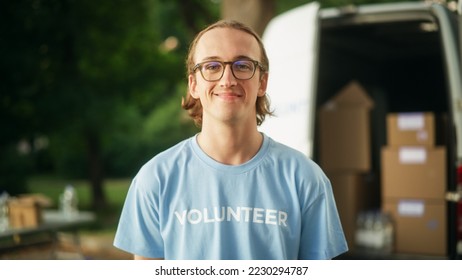 Portrait of an Attractive Young Male Volunteer. Happy Caucasian Man in Glasses, Wearing a Blue T-Shirt, Smiling, Posing for Camera. Humanitarian Aid, Donations Center and Volunteering Concept. - Powered by Shutterstock