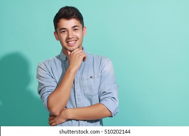 Portrait Of An Attractive Young Man Posing Against Blue Background