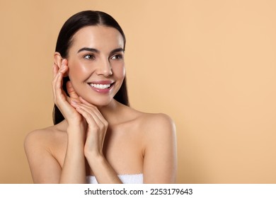Portrait of attractive young woman on beige background, space for text. Spa treatment