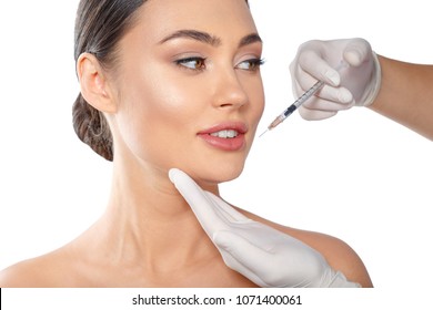 Portrait of an attractive young woman receiving botox treatment.