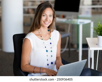 Portrait of an attractive young woman using her laptop - Shutterstock ID 250936405