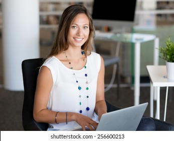Portrait of an attractive young woman using her laptop - Shutterstock ID 256600213