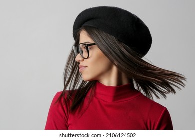 Portrait Of Attractive Young Woman Wearing Reading Glasses And Black Beret.