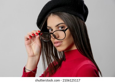 Portrait Of Attractive Young Woman Wearing Reading Glasses And Black Beret.