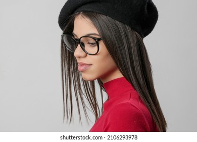 Portrait Of Attractive Young Woman Wearing Reading Glasses And Black Beret.