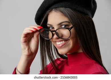 Portrait Of Attractive Young Woman Wearing Reading Glasses And Black Beret.