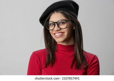 Portrait Of Attractive Young Woman Wearing Reading Glasses And Black Beret.