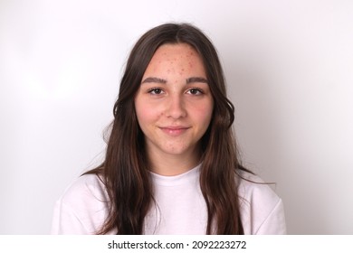 Portrait of authentic cute teenage girl without makeup on light background