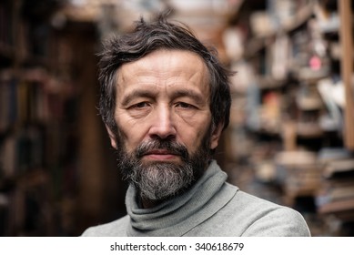 Portrait Of Authentic Senior Man With Beard And Mustache On Book Market