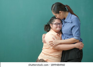 Portrait of Autism student kids and her teacher helping with lovely hug and sweet kiss