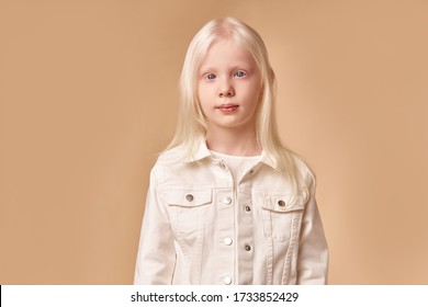 portrait of awesome albino kid with blonde hair. Fashion style and beauty look. Child with unusual young tender white skin. albinism, children, people diversity concept