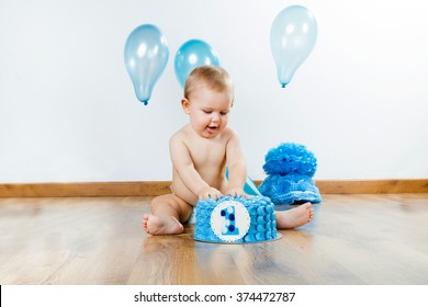 Portrait Of Baby Boy Celebrating Her First Birthday With Gourmet Cake And Balloons.