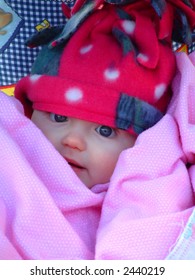 Portrait Of Baby Bundled Up In Winter Clothing To Stay Warm