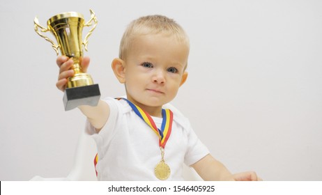 Portrait Of Baby Child Rising Up Golden Cup, Kid Offering His Victory Trophy, Generous Attitude, Conceptual