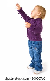 Portrait Of Baby Girl Looking Up To Reach Something