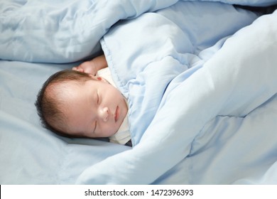 Portrait Of Baby Girl Sleep On The Bed In Her Room, In The Blue Quilt, Soft Focus