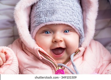 Portrait Of Baby Girl In Winter Jacket And Hat