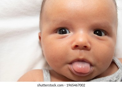 Portrait Of Baby Sticking Out Tongue Close Up