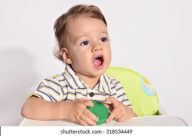 Portrait Of A Baby, Toddler With Big Black Eyes Looking Playing Talking, Screaming