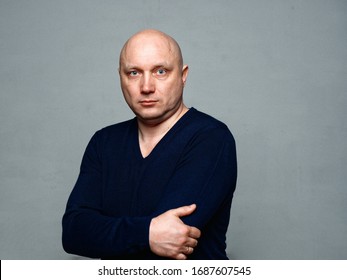 Portrait of a bald cheerful man on a gray background - Shutterstock ID 1687607545