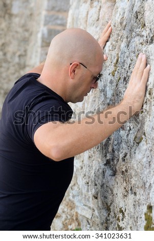 Similar – Little boy looking through the wall of a castle