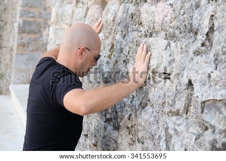 Similar – Little boy looking through the wall of a castle