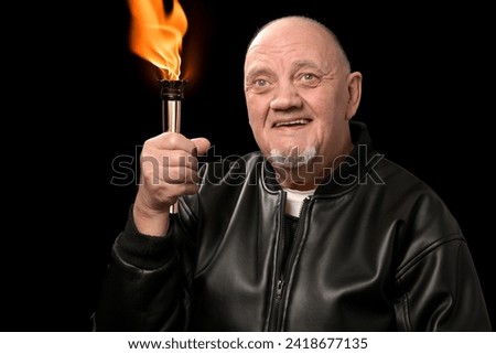 portrait bald man with olympic flame in his hand