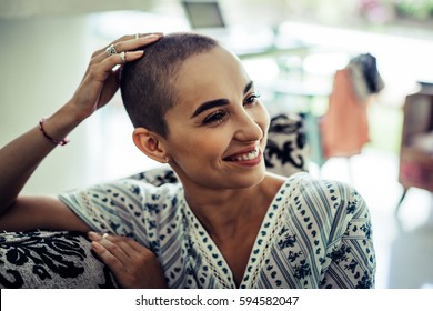 Portrait of a bald woman in a living room in a cozy house in the morning. - Shutterstock ID 594582047