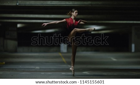 Portrait of ballet dancer on pointe in an underground car park