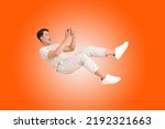 Portrait banner of a young handsome Asian adult man, floating and using smart phone, isolated on color background. concept of smart phone entertainment