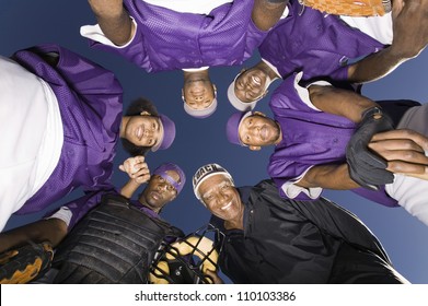 Portrait Of A Baseball Team Standing In A Huddle