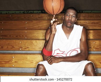 Portrait of a basketball player ball spinning ball on finger  - Powered by Shutterstock