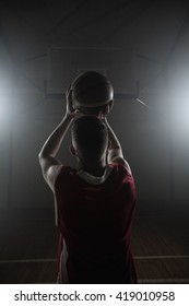 Portrait Of Basketball Player Front The Back Preparing To Score On A Gym