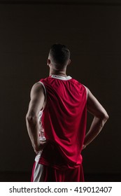 Portrait Of Basketball Player Front The Back Posing On A Gym