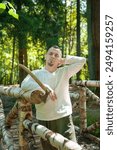 Portrait of a bearded axeman working in a sunlit woodland. The peaceful environment and rich timber background emphasize the cultural heritage and artisanal skills of forestry