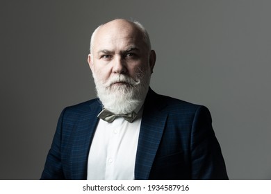 Portrait Of A Bearded Middle-aged Man Over A Gray Studio Background With Copyspace. Serious Senior Man