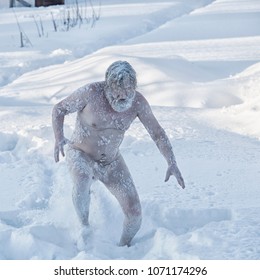Portrait of a bearded naked man in the snow