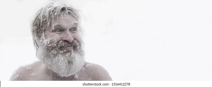 Portrait of a bearded naked man in the snow 