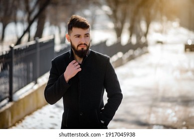 Portrait Of Bearded Stylish Young Handsome Man In Black Coat Outside. 