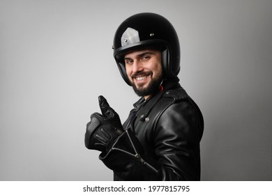 Portrait Of Bearded Young Male Model Wears Biker Helmet And Leather Jacket.