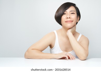 Portrait Of A Beautiful 30s Asian Woman In White Inner Wear With Flawless Face Smiling With Satisfy. K-beauty, Collagen, Skincare, Hair Products, Clinic, Plastic Surgery, V Shape, Skin Radiance, 40s.