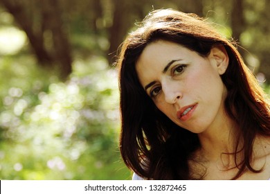 Portrait of beautiful 35 years old woman in summer forest