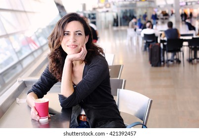 Portrait of beautiful 40 years old woman holding cup of coffee
