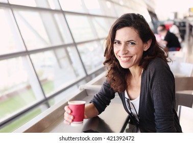 Portrait of beautiful 40 years old woman holding cup of coffee