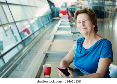 Portrait Of Beautiful 70 Years Old Woman Sitting In The Airport