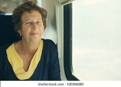 Portrait Of Beautiful 70 Years Old Woman Sitting In The Train