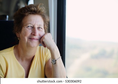 Portrait Of Beautiful 70 Years Old Woman Sitting In The Train